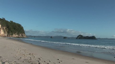 Wide shot from see at beach with people and houses, New Zealand
