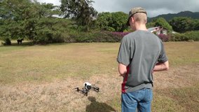 Male Operator with Remote Controls Drone in Takeoff