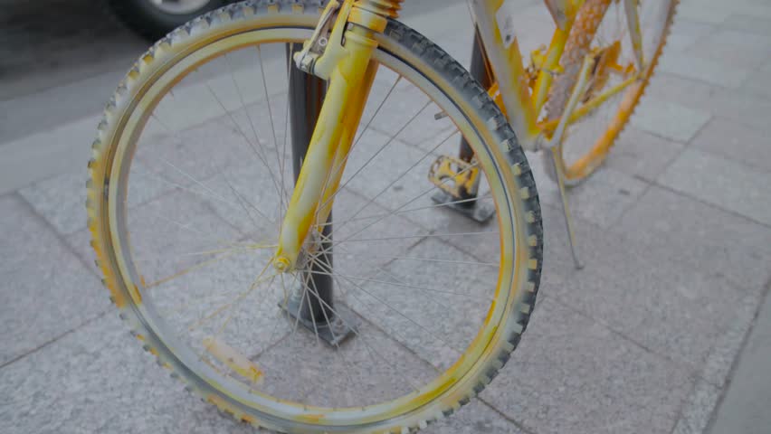 Train passes a parked yellow bike in downtown Salt Lake City, UT.
