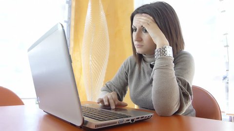depressed businesswoman at work with laptop computer