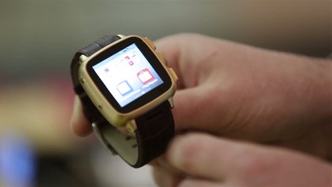 MOSCOW, RUSSIA - MARCH 29, 2015: Man demonstrates the capabilities of smart watch. Close-up.