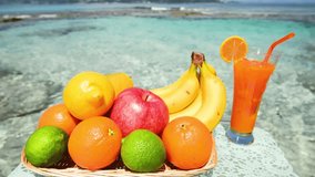 Fresh fruits, juice drinks on a beach 