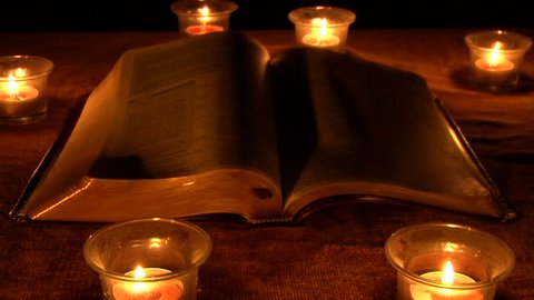 a book surrounded by candles