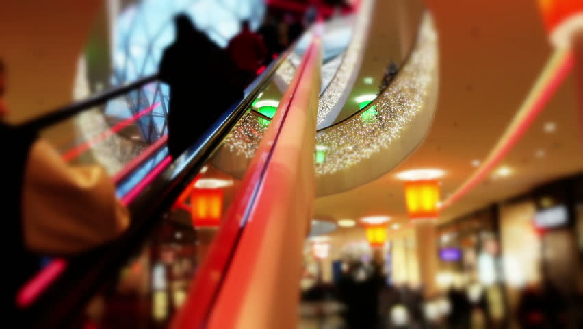 Consumer on escalators in shopping mall