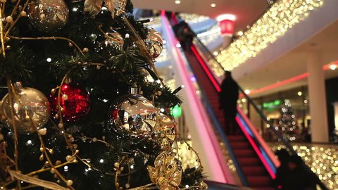 Consumer on escalators in shopping mall at christmas time