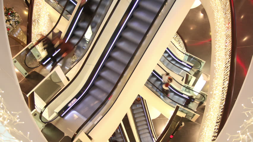 Consumer on 4 escalators in shopping mall  - Time lapse