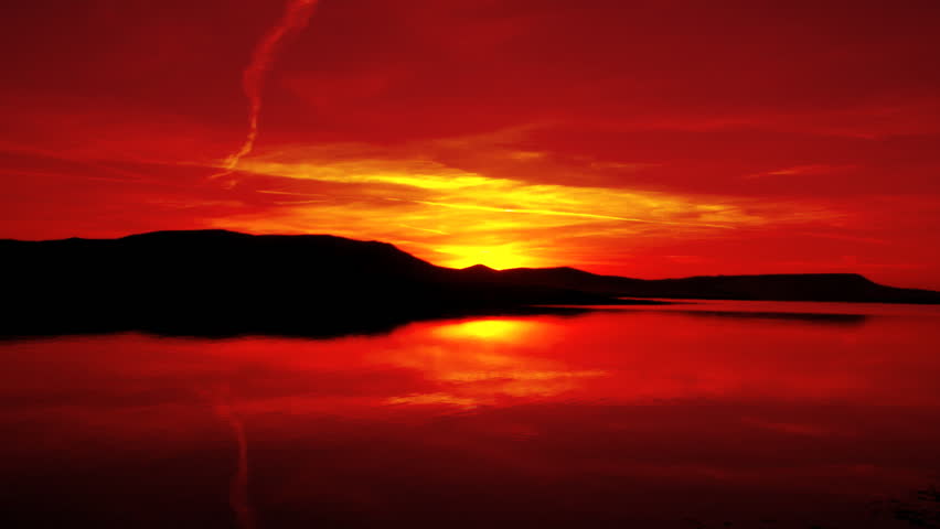 red sunrise on morning lake with mountain
