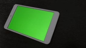 PC tablet green screen display on wooden table 4K 2160p UltraHD footage -Silver PC tablet with greenscreen display on table 4K 3840X2160 slow tilting UHD video