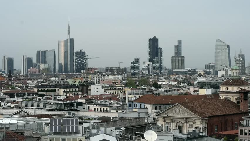 Milan, new panoramic skyline on a cloudy day. The new buildings and skyscrapers of the Garibaldi and Porta Nuova district are on the background with lights .