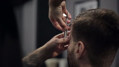 Barber Cuts the Hair in the Barbershop. Slow Motion. Close Up