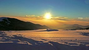4K Beautiful sunset high in the mountains covered with snow. UHD steadycam stock video