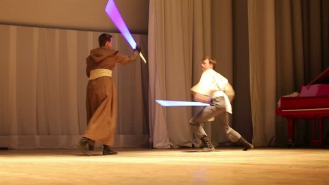 MOSCOW, RUSSIA - MARCH 28, 2015: Star Wars Cosplay show. Jedi lightsaber battle on the stage during the festival Star Fans.