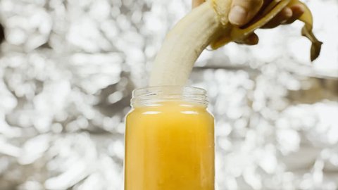 Plunging a peeled banana in a jar of yellow honey. Visual metaphor for a certain type of sexual intercourse: use it when you must visually show but you can't put the real thing.