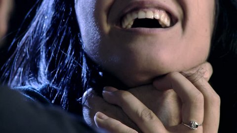 Closeup of hand strangling and hitting woman domestic violence
