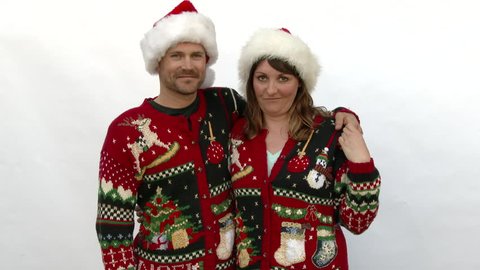 Model released man and woman wearing ugly Christmas sweaters in studio, 2 clip sequence.