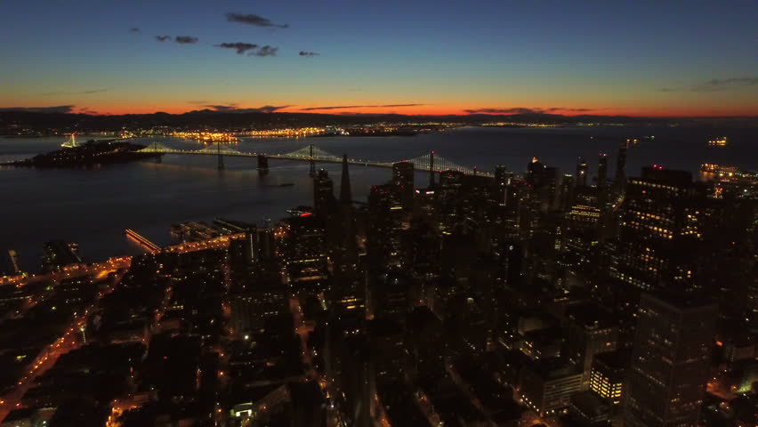 San Francisco Aerial v12 Flying backwards over downtown at dawn.