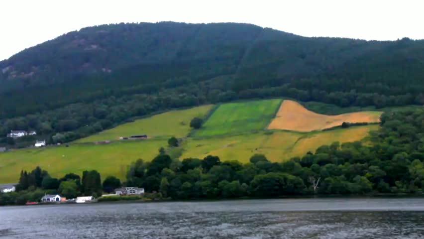 Loch Ness, the most famous lake in Scotland at typical summer cloudy evening. Shooting from the ship rocking on the waves