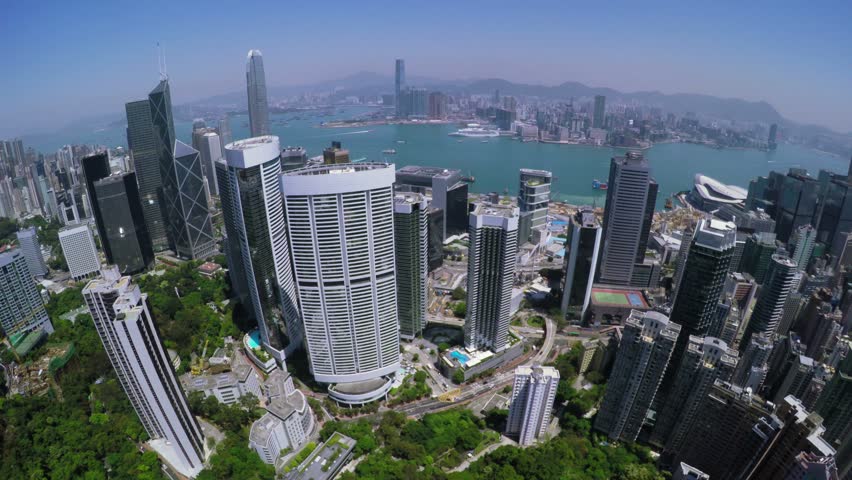Hong Kong City Aerial. Beautiful Clear Blue Sky.
4K Aerial view capturing the general Hong Kong and Kowloon Island. Wide aerial crank up movement shot.
