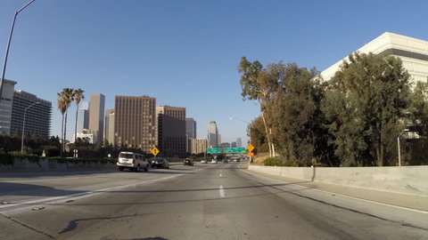 LOS ANGELES, CALIFORNIA, USA - April 19, 2015:  Driving time lapse through the Sepulveda Pass on the San Diego 405 Freeway in the city of Los Angeles.  