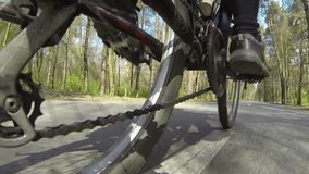 Feet of  cyclist  slowly twist  chain. POV clip in spring day
