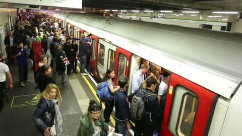 LONDON - CIRCA SEPTEMBER 2014, London underground subway train station time-lapse,  train arrives & unidentified crowds of people move to disembark & embark the train, London September 2014