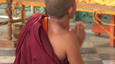 BAGO, BAGO REGION/MYANMAR - FEBRUARY 07, 2015: Unidentified monk prays at Reclining buddha, Shwethalyaung Pagoda, Burma. The Buddha is the second largest Buddha in the world.