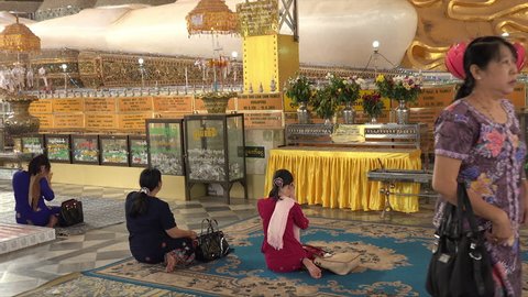 BAGO, BAGO REGION/MYANMAR - FEBRUARY 07, 2015: Unidentified Burmese people pray at Reclining buddha, Shwethalyaung Pagoda, Burma. The Buddha is the second largest Buddha in the world.