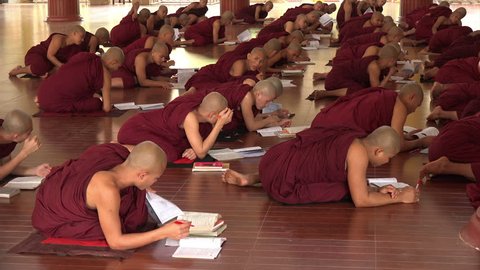 BAGO, BAGO REGION/MYANMAR - FEBRUARY 07, 2015: Unidentified Monks in Monastery learning with books in class. Burma has the most monks in proportion to the population.