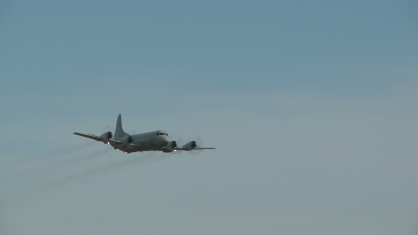 A P3 Orion flying straight and level and then climbing out at a steep angle