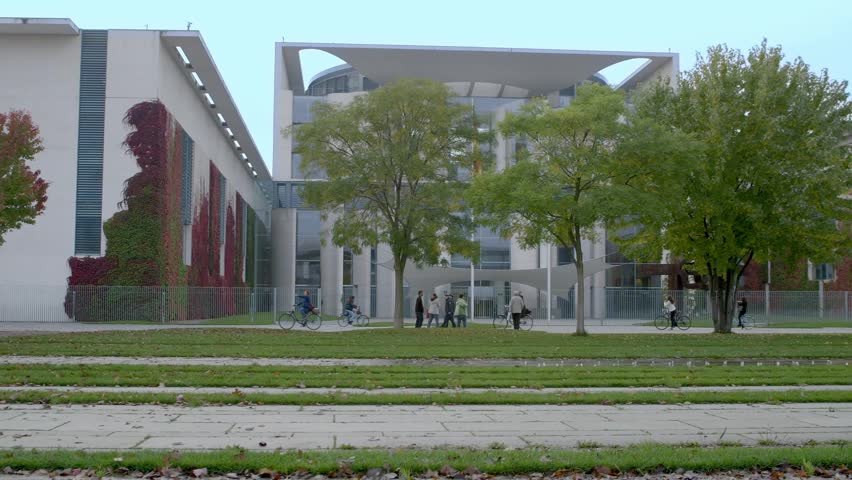 Berlin German chancellor's office in the fall , fountain starts, people pass by



 Royalty-Free Stock Footage #9691400