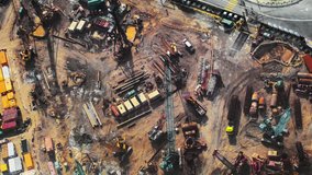 Top view timelapse video of construction site in beginning of building new housing project in Hong Kong. Workers and machinery move fast and busy on development area 
