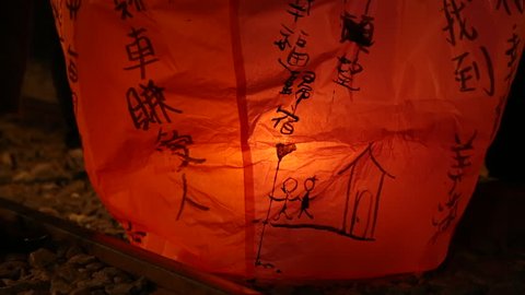 People launching asian lanterns during buddhist festival, rice paper hot air balloons are launched during traditional flying lantern from Pingxi in Taiwan -Dan