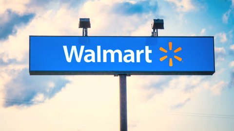 MIAMI, FL - April 22, 2015: (Timelapse) Walmart sign with time lapse clouds and sky on April 22, 2015. Walmart is an American multinational retail corporation with a chain of department and warehouse stores.
