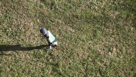 Video Boy playing on the grass in a football. Top view.