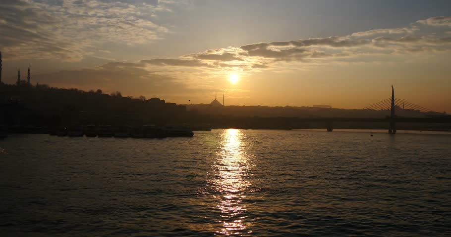 ISTANBUL - MARCH 30: Beautiful sunset in Istanbul over the Golden Horn with mosques in the background 4K 30, 2015 in Istanbul, Turkey.