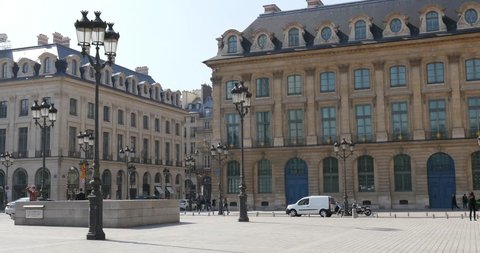 PARIS, FRANCE - APRIL 8, 2015: People walking in Place Vendome. The Place Vendome has been renowned for its fashionable and deluxe hotels such as the Ritz.
