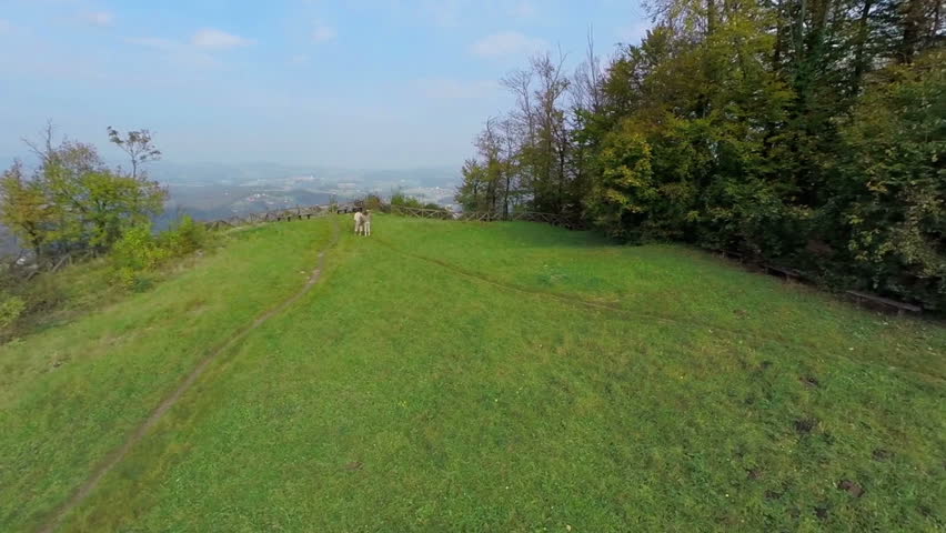 Beautiful lookout spot over the countryside. helicopter camera flaying over the filed on the hill with beautiful view over the countryside on a sunny summer day.