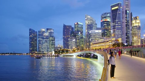 SINGAPORE - CIRCA APRIL 2015: City skyline, Marina Bay and Raffles Place, view at night, time-lapse in motion, hyperlapse.