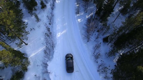 the car rides on a winter road among the woods and mountains HD