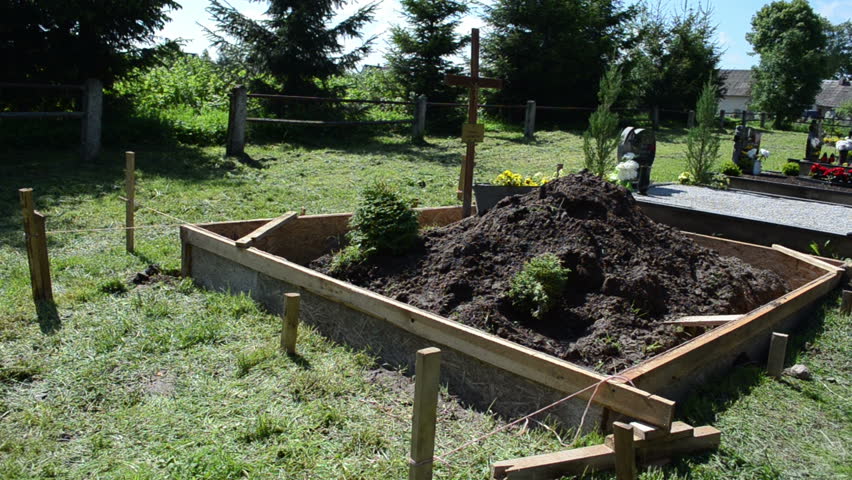 Freshly made grave soil and foundation in cemetery. Turn view panorama in graveyard.