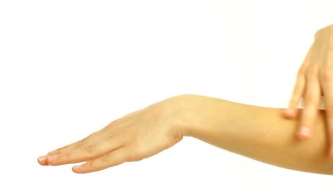Closeup of beautiful female hands applying hand cream 