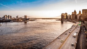 Timelapse transition frome sunset to dusk with Brooklyn Bridge, boats sailing East River and FDR drive traffic. For the 4k version check clip ID 9861107