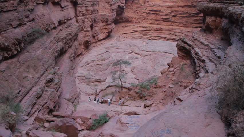 Impressive rock formation "garganta del diablo" at the Cafayate valley in Salta prov., Argentina. Tourists stroll around. Some graffiti is visible down right (1080p, C.7D).