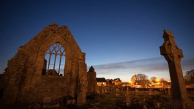 Night view of Athenry Dominican Friary, dedicated to Saints Peter and Paul,found at 1241, with cemetery. Time lapse video.