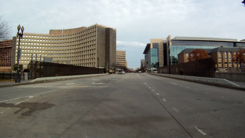 A handheld shot of driving down a straight road in Washington DC.