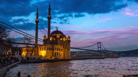 Day to night time lapse scene of the beautiful renovated Ortakoy mosque in Istanbul with Bosphorus bridge in the background. 4K Time-Lapse. 
