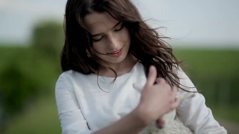 girl holds on hands lamb
