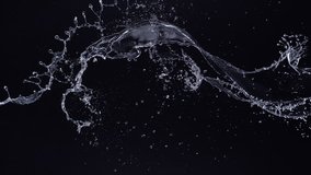 Water splash in midair against black background. Shot with high speed camera, phantom flex 4K. Slow Motion. Unedited version is included at the end of clip.