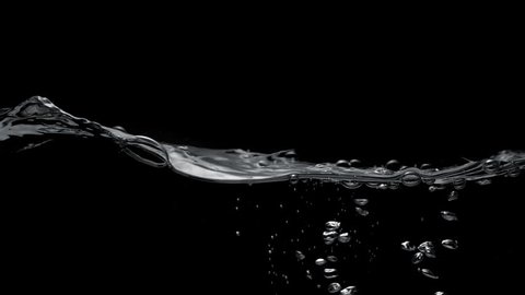 Water surface splash against black background. Shot with high speed camera, phantom flex 4K. Slow Motion.