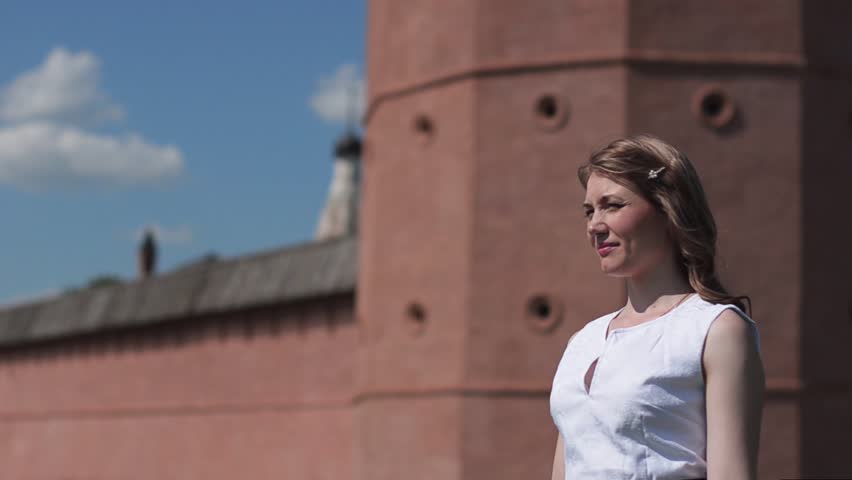 Beautiful young woman walking in a Park one summer